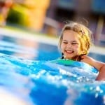 Little girl in pool with floatie