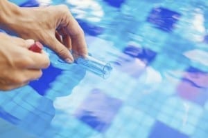 Analyzing of a water from swimming pool, taking water sample to