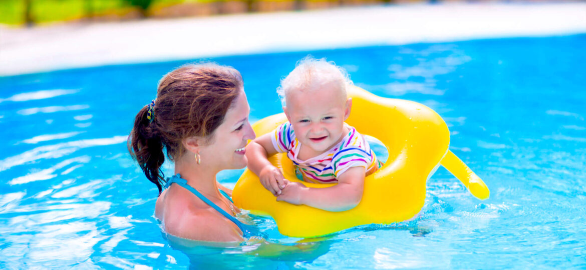 Mother and baby in swimming pool