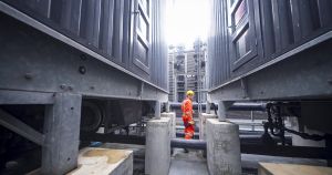 worker inspects industrial equipment in a confined space